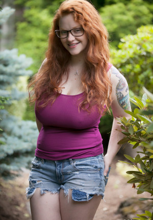 Glasses wearing big tits redhead Kaycee Barnes flashing her boobs in the woods