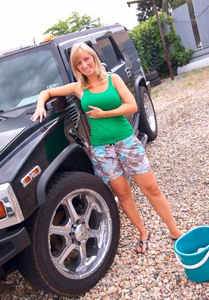 Curvy blonde Nikol washing a car with her big butt and big tits out in the sun