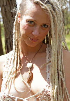 Natural curvy blonde with dreadlocks named Sunday relaxing in the woods