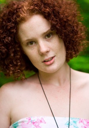 Curly haired redhead with freckles Maria S playing in the grass nude after pulling off her jeans