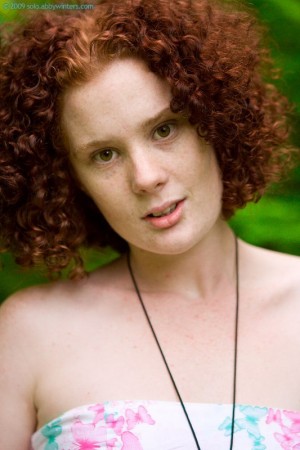 Curly haired redhead with freckles Maria S playing in the grass nude after pulling off her jeans