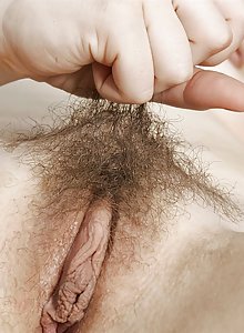 Jette feels herself up andparts the lips of her dripping hairy pussy