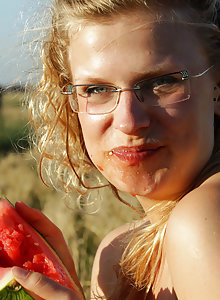 Sweet and succulent Gretel takes a break from her busy backpacking schedule and jumps in the wheat field with a giant big red watermelon.